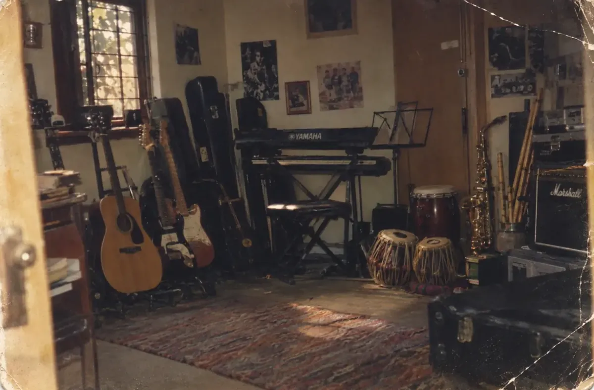 A teaching room filled with guitars, a keyboard, percussion and an amplifier
